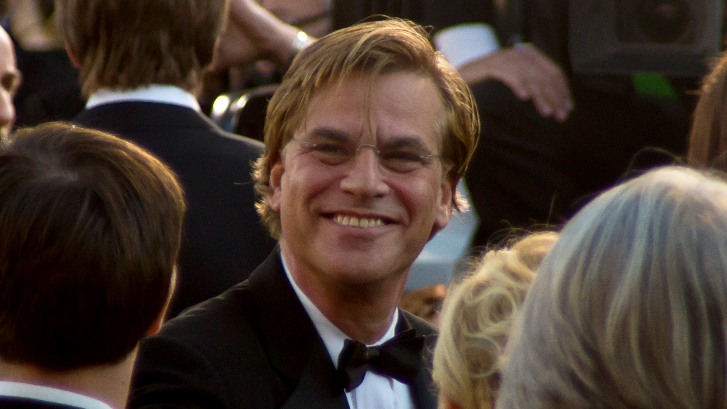 Aaron Sorkin, wearing a tuxedo and bowtie, in a crowd